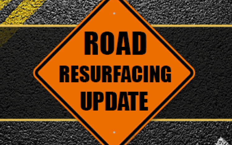Image of traffic detour sign; text reads, "Road Resurfacing Update"